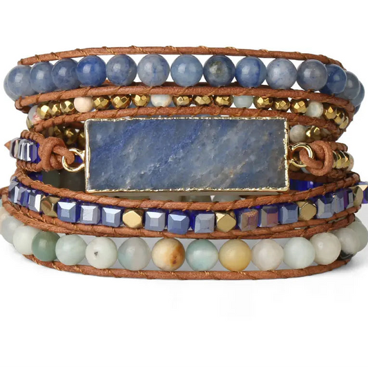 Multistrand bracelet with blue beads, gold accents, and a stone panel on a white background.